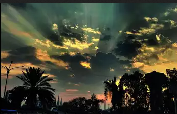 The city awakens to a sky adorned with scattered clouds .